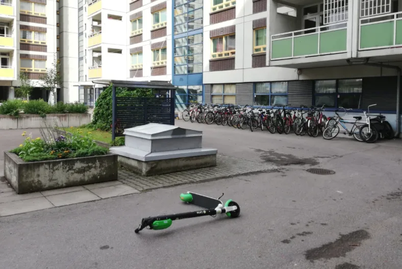 Another e-scooter abandoned on a sidewalk